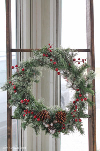 Use a rustic wood ladder to hang a winter wreath for the holidays.