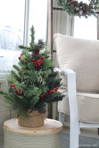 Cut pieces of wood to fit over your planting containers and add a pretty evergreen tree to decorate for winter!