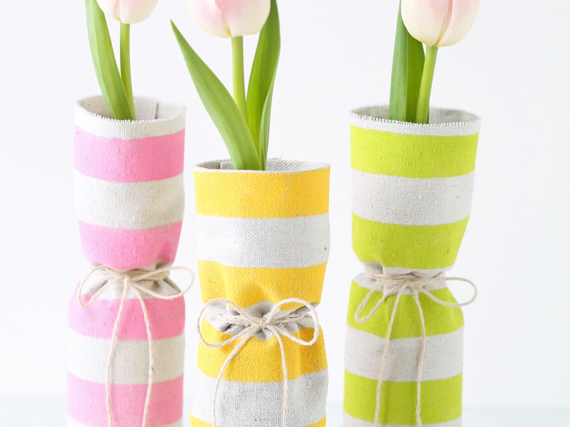 Use recycled bottles and a bit of fabric to create beautiful spring vases! A gorgeous way to display those spring flowers! | LoveGrowsWild.com