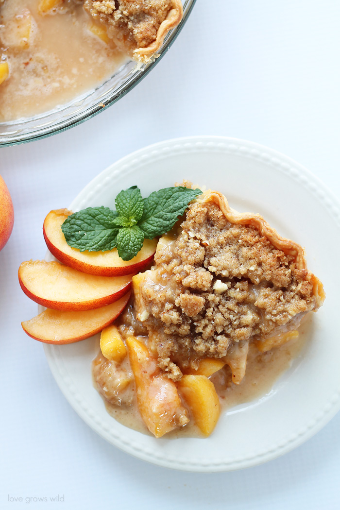 Enjoy the best flavors of summer with this perfect Peach Pie recipe topped with a delicious almond crumble! | LoveGrowsWild.com