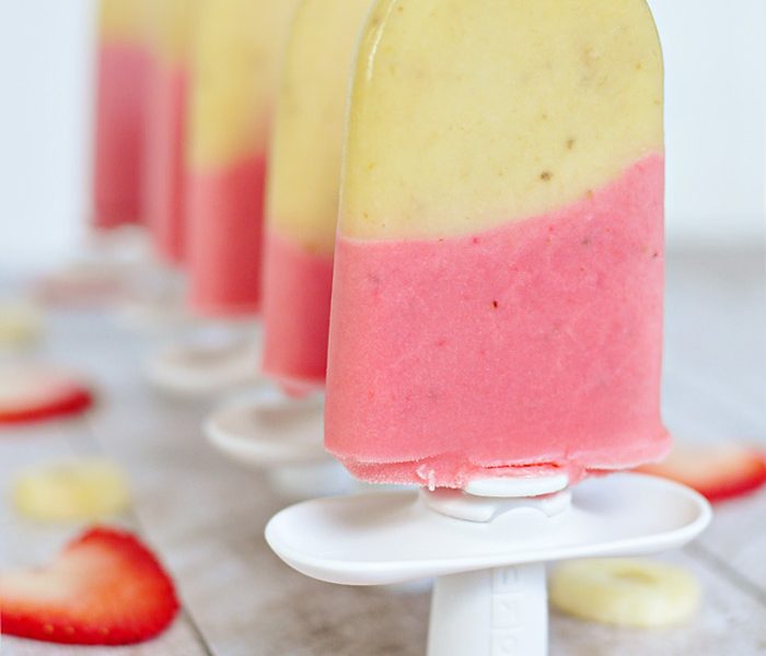 Cold and creamy Strawberry Banana Popsicles are the perfect summertime treat! | LoveGrowsWild.com