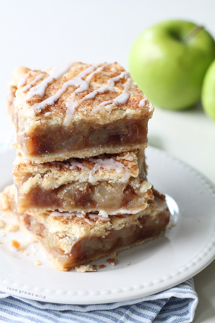 These Apple Pie Bars are the perfect handheld dessert and SO delicious! Made with fresh apples and topped with a sweet vanilla glaze! | LoveGrowsWild.com