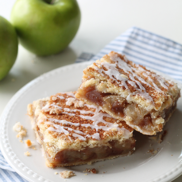 These Apple Pie Bars are the perfect handheld dessert and SO delicious! Made with fresh apples and topped with a sweet vanilla glaze! | LoveGrowsWild.com