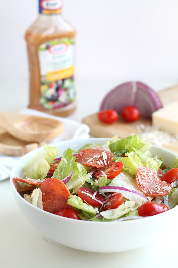 A simple, fresh Italian Salad is a great healthy meal idea! Crisp lettuce, spicy pepperoni, juicy tomatoes, and the perfect Italian dressing! | LoveGrowsWild.com