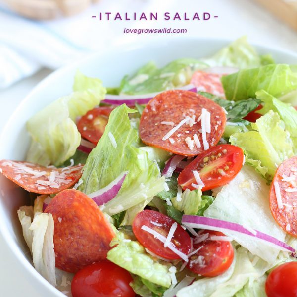 A simple, fresh Italian Salad is a great healthy meal idea! Crisp lettuce, spicy pepperoni, juicy tomatoes, and the perfect Italian dressing! | LoveGrowsWild.com