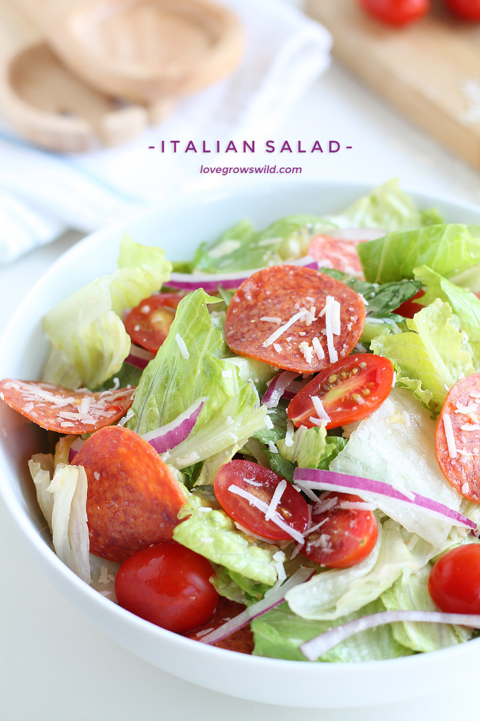 A simple, fresh Italian Salad is a great healthy meal idea! Crisp lettuce, spicy pepperoni, juicy tomatoes, and the perfect Italian dressing! | LoveGrowsWild.com