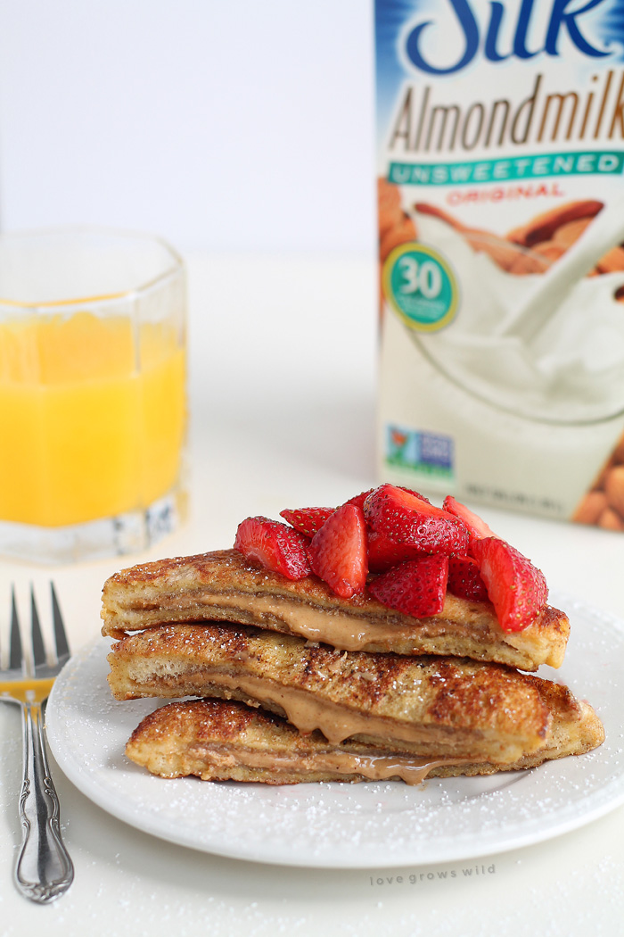 A decadent french toast recipe stuffed with creamy peanut butter and topped with fresh strawberries! This is one amazing breakfast! | LoveGrowsWild.com