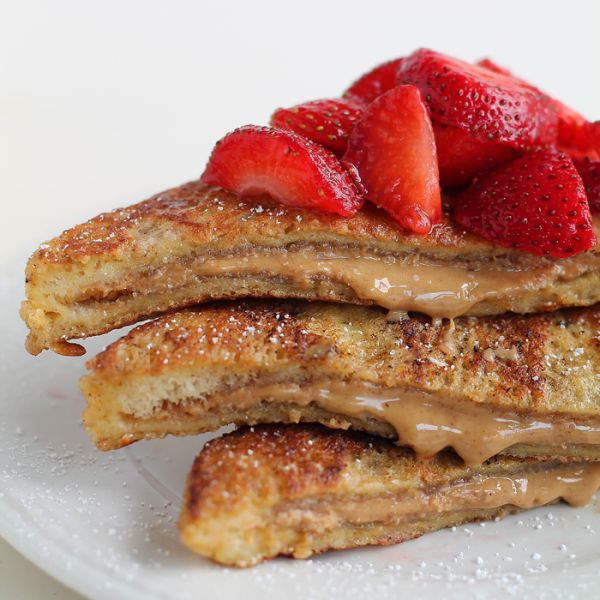 A decadent french toast recipe stuffed with creamy peanut butter and topped with fresh strawberries! This is one amazing breakfast! | LoveGrowsWild.com