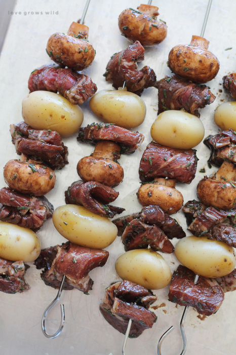 Steak, potato, and mushroom kabobs are soaked in a flavorful balsamic rosemary marinade and grilled to perfection! This takes steak and potatoes to a whole new level! | LoveGrowsWild.com
