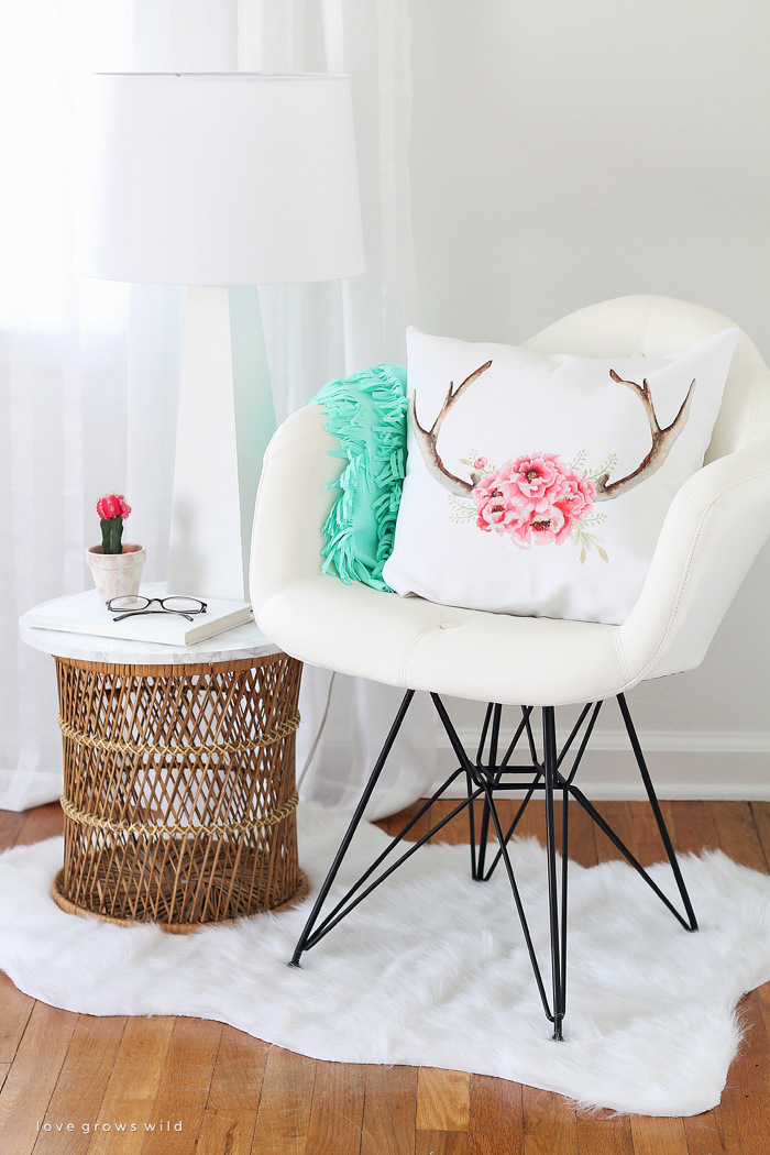 A comfy chair, faux fur rug, cute pillows, and a lamp - all you need for a cozy reading nook! See more photos of my office makeover at LoveGrowsWild.com