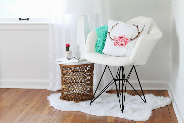 A comfy chair, faux fur rug, cute pillows, and a lamp - all you need for a cozy reading nook! See more photos of my office makeover at LoveGrowsWild.com