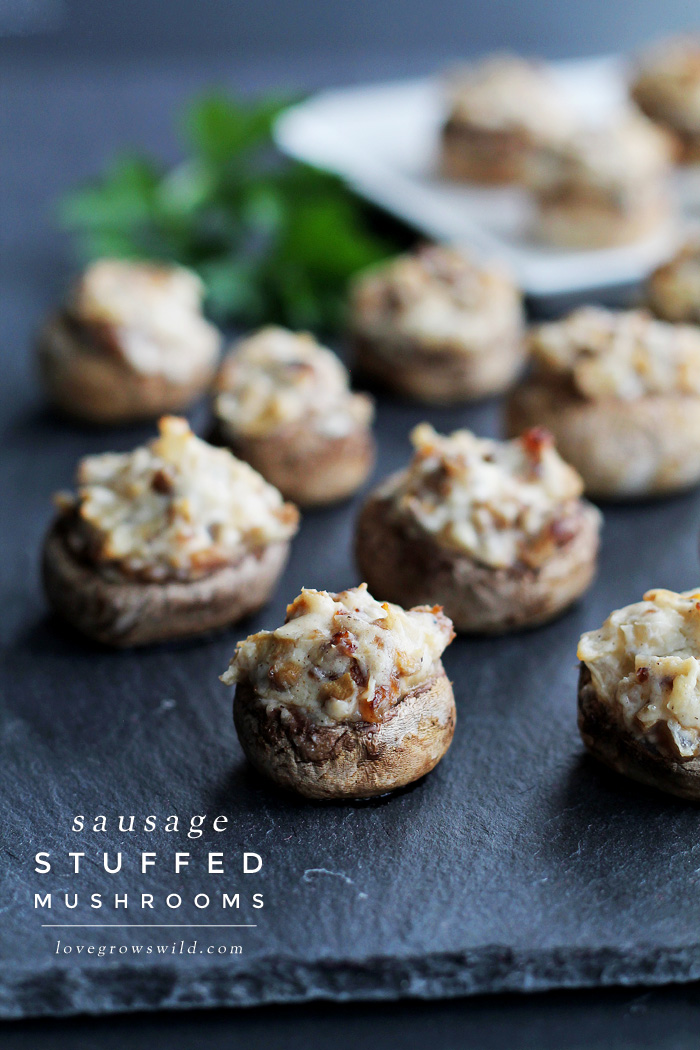 Creamy, delicious Sausage Stuffed Mushrooms make the perfect party appetizer! Get the recipe for these savory little bites of heaven at LoveGrowsWild.com