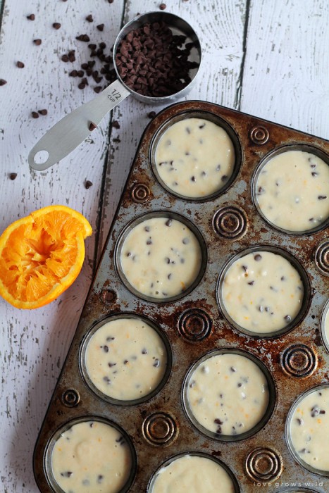Sweet orange muffins loaded with chocolate chips and drizzled with a delicious orange glaze! The chocolate-citrus combination is so yummy and perfect for breakfast or snack time! | LoveGrowsWild.com