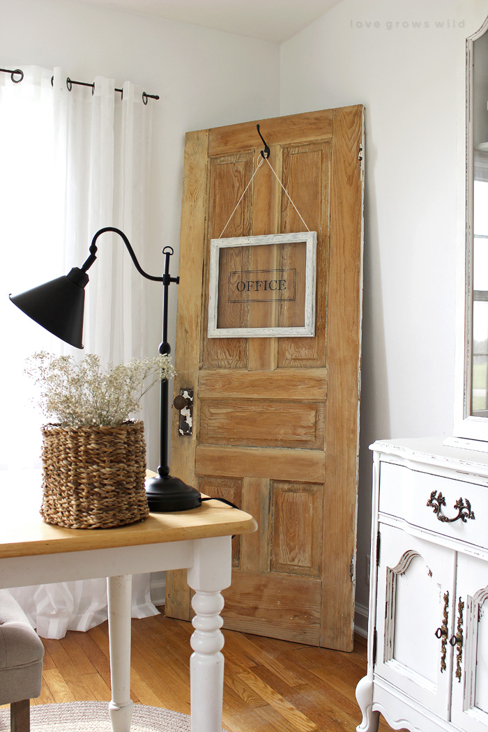 Turn any picture frame into a hanging sign! See more photos of this gorgeous farmhouse office decorated  with an old door at LoveGrowsWild.com