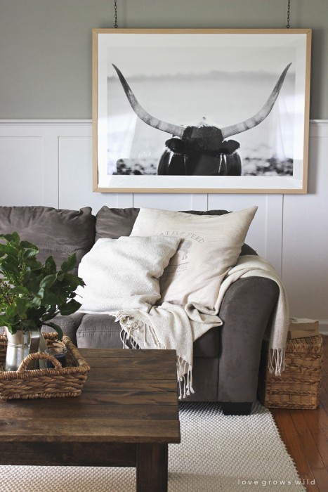 Instead of a gallery wall, try a large piece of art that makes a big impact in the room. Add interest by hanging it from the ceiling with this tutorial from LoveGrowsWild.com!