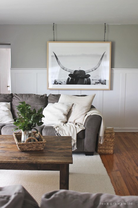 Instead of a gallery wall, try a large piece of art that makes a big impact in the room. Add interest by hanging it from the ceiling with this tutorial from LoveGrowsWild.com!