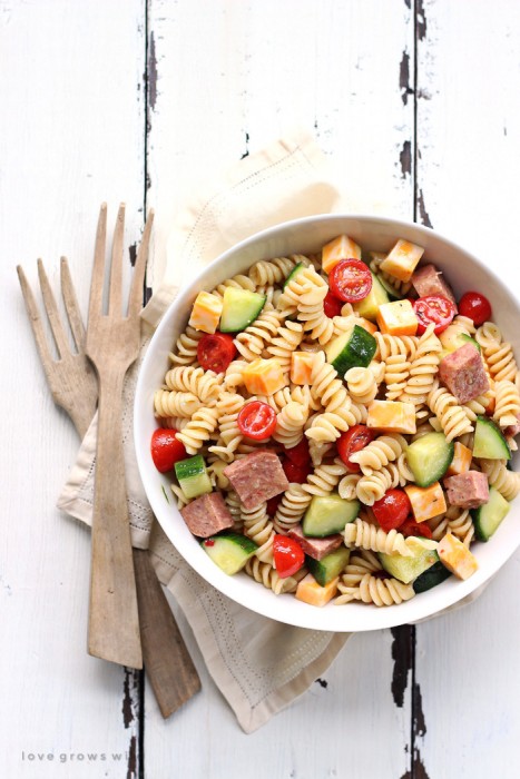 The perfect pasta salad recipe! Tender noodles tossed in a zesty Italian dressing with vegetables, meat, and cheese... great for a potluck or a light meal! | LoveGrowsWild.com