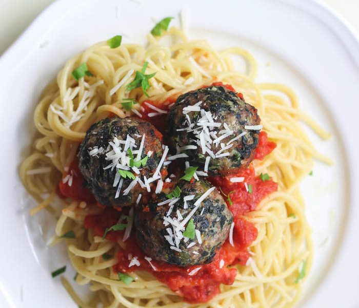 This recipe takes spaghetti and meatballs up a notch! Delicious Florentine Meatballs made with spinach and parmesan cheese are roasted in the oven then finished in a tasty marinara sauce. | LoveGrowsWild.com