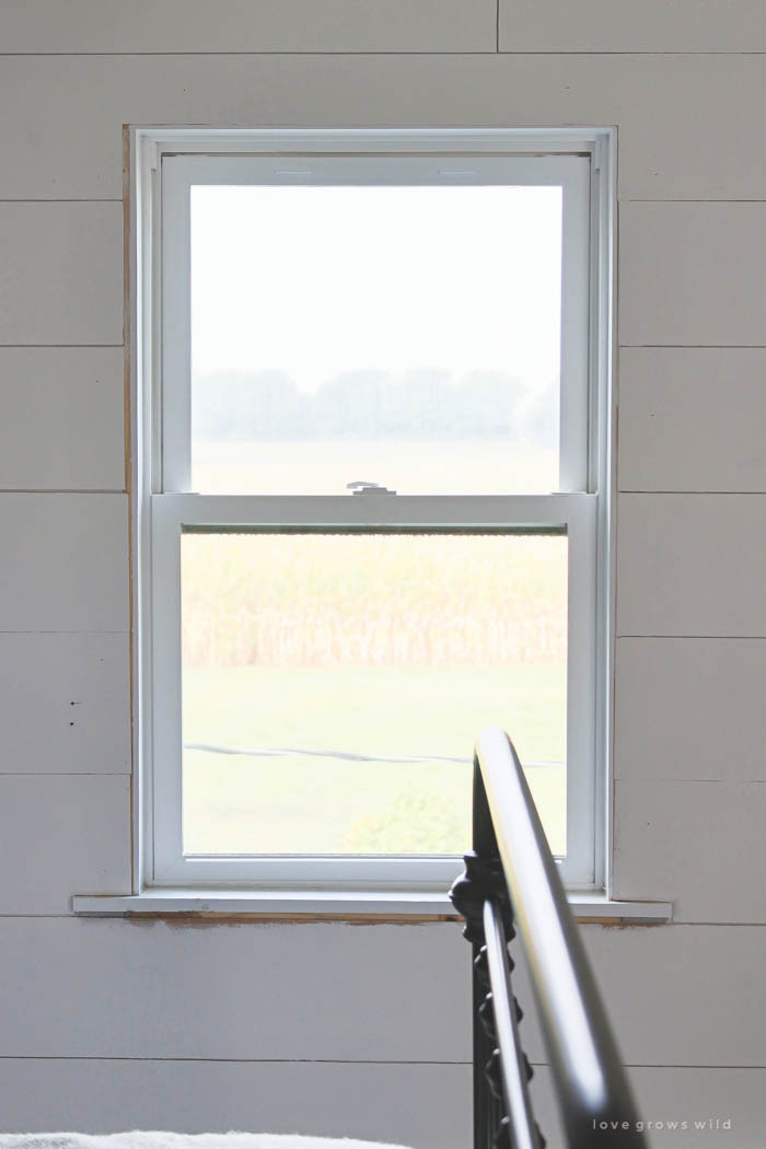 Learn how to bulk up the trim around your windows for a beautiful farmhouse look! Such an easy and inexpensive upgrade! | LoveGrowsWild.com