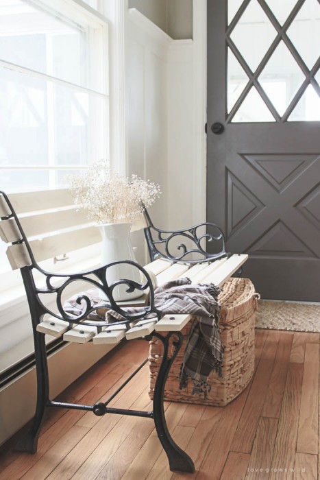 Check out this trash to treasure transformation! An old wood and cast iron bench is refinished and used in a beautiful farmhouse entryway. See photos at LoveGrowsWild.com
