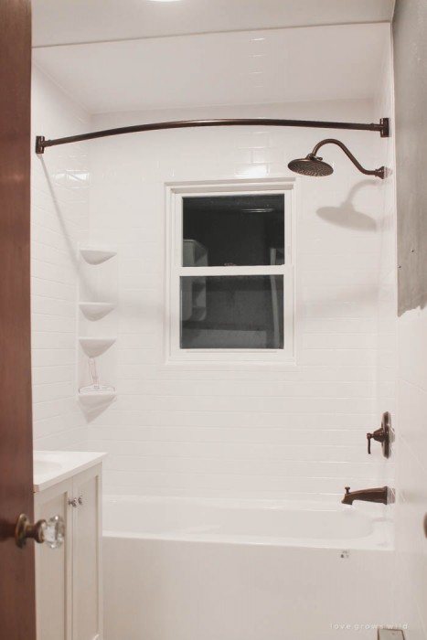 Follow along the big makeover of LoveGrowsWild.com's bathroom! In this post, Liz shares the bathtub and shower installation. Click to see more!