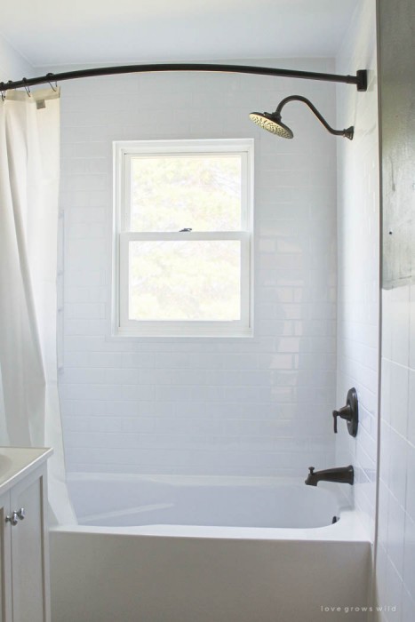 Follow along the big makeover of LoveGrowsWild.com's bathroom! In this post, Liz shares the bathtub and shower installation. Click to see more!