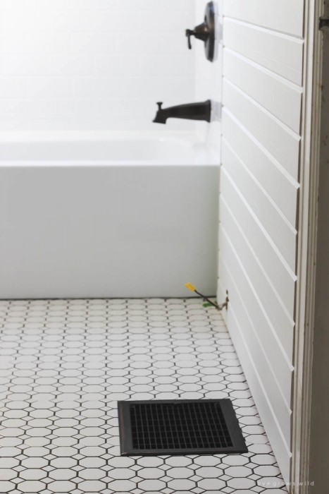 Follow along the big makeover of this beautiful farmhouse bathroom! In this post, Liz shares her tile choice for flooring. Click to see more photos at LoveGrowsWild.com