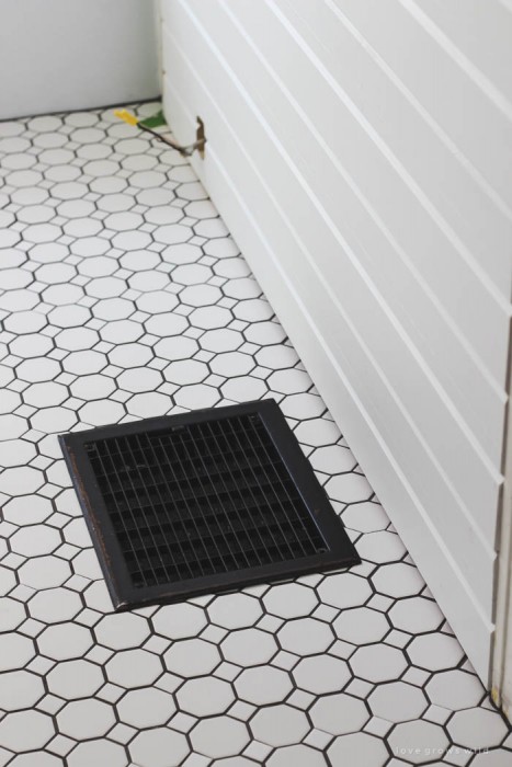 Follow along the big makeover of this beautiful farmhouse bathroom! In this post, Liz shares her tile choice for flooring. Click to see more photos at LoveGrowsWild.com
