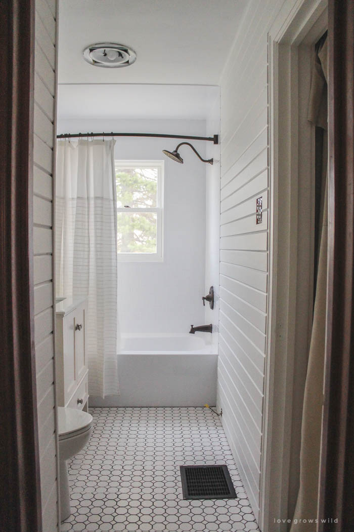 Follow along the big makeover of this beautiful farmhouse bathroom! In this post, Liz reveals her new planked walls, vanity, and closet! Click to see more photos at LoveGrowsWild.com