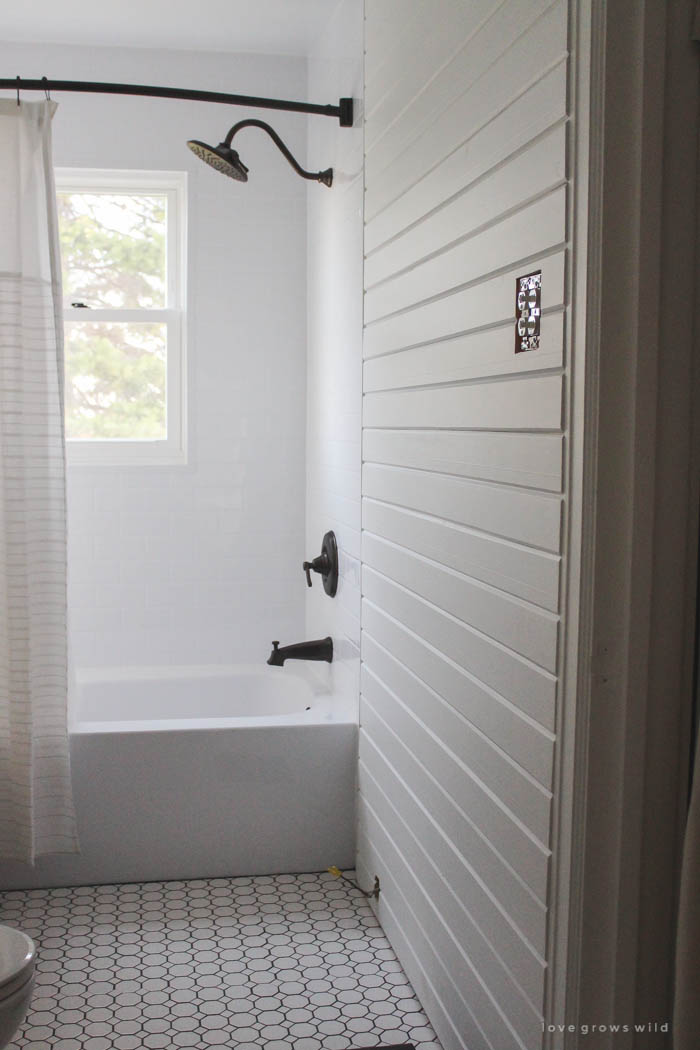 Follow along the big makeover of this beautiful farmhouse bathroom! In this post, Liz reveals her new planked walls, vanity, and closet! Click to see more photos at LoveGrowsWild.com