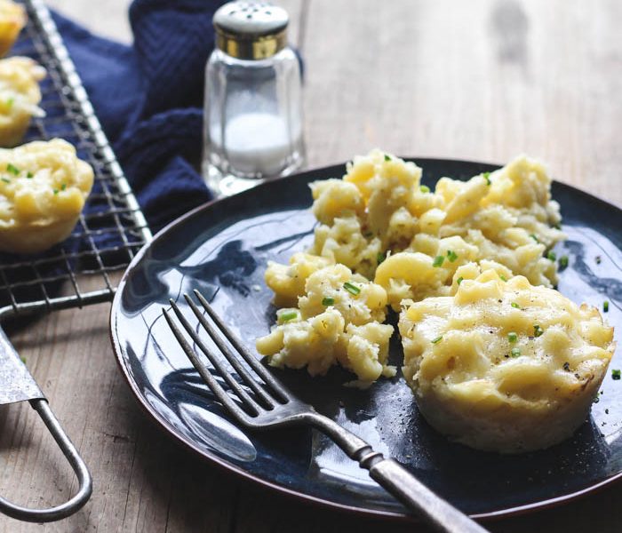 Delicious, creamy mac and cheese baked in little muffin tins for perfect individual portions! Freezes and re-heats beautifully and sneaks in a serving of veggies! Recipe at LoveGrowsWild.com