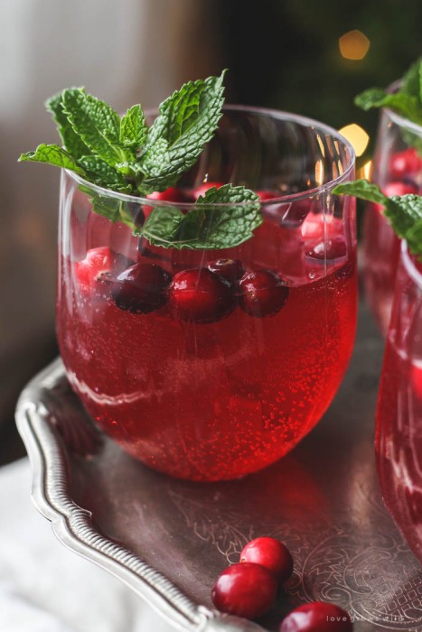 This non-alcoholic Cranberry Holiday Punch is a must for your next holiday party! Serve with cranberries and mint leaves for a beautiful presentation. | LoveGrowsWild.com