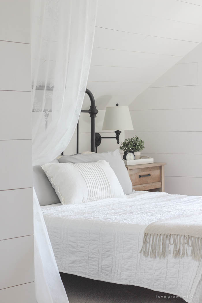 Lots of stylish, affordable furniture options in this farmhouse master bedroom! Click for more photos and details at LoveGrowsWild.com