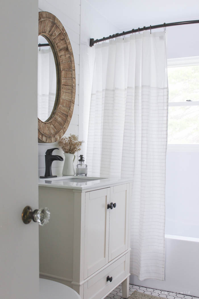 See the big reveal of this beautiful farmhouse bathroom makeover! Click for before and after photos and details at LoveGrowsWild.com