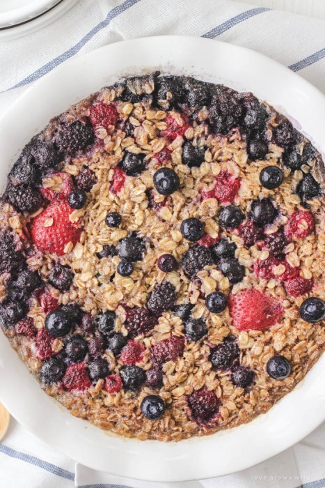 Enjoy a bowl of this warm, delicious Triple Berry Baked Oatmeal for breakfast! Easy to make and baked right in the oven... perfect for serving a crowd! | LoveGrowsWild.com