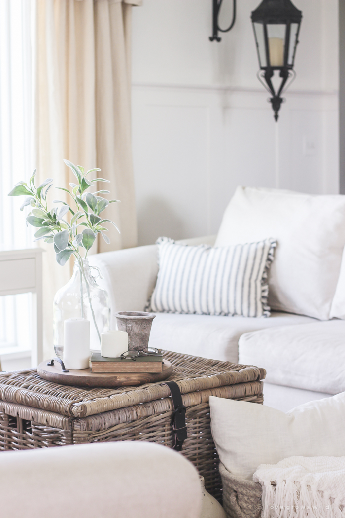 A cozy farmhouse living room with beautiful linen slipcovered sofas. See how to get this custom slipcovered look at LoveGrowsWild.com!