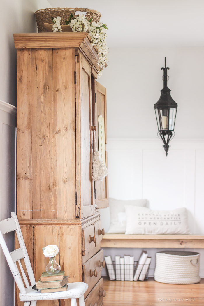 A gorgeous antique armoire decorated for spring in a lovely, little farmhouse. See more photos at LoveGrowsWild.com