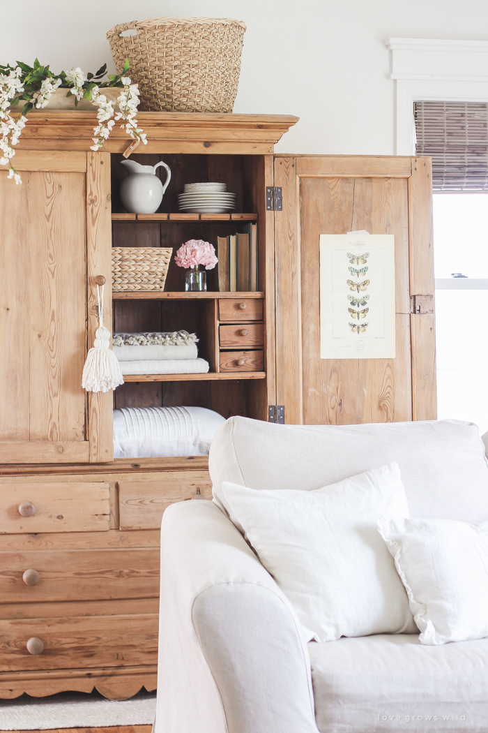 A gorgeous antique armoire decorated for spring in a lovely, little farmhouse. See more photos at LoveGrowsWild.com