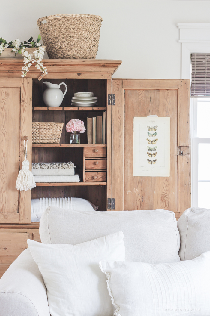 A gorgeous antique armoire decorated for spring in a lovely, little farmhouse. See more photos at LoveGrowsWild.com