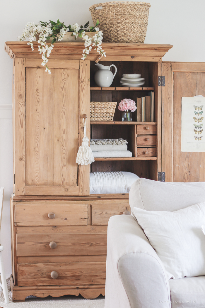 A gorgeous antique armoire decorated for spring in a lovely, little farmhouse. See more photos at LoveGrowsWild.com