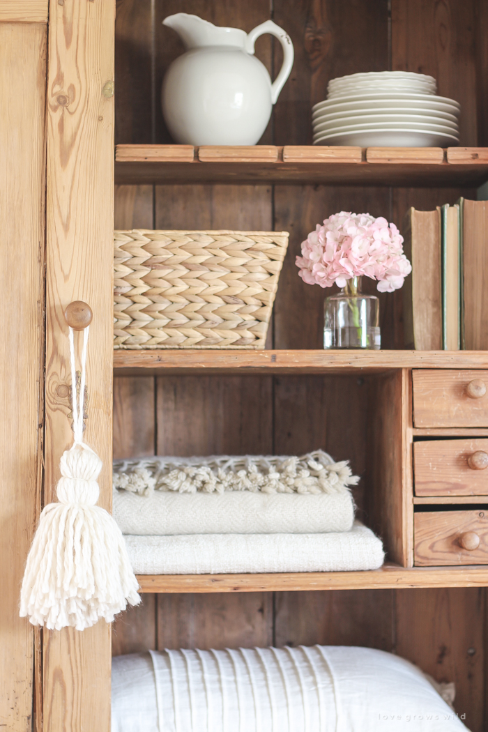 A gorgeous antique armoire decorated for spring in a lovely, little farmhouse. See more photos at LoveGrowsWild.com