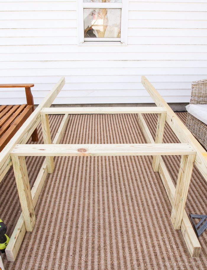 This stunning DIY potting bench is full of charm and perfect for a deck or patio! Use it to hold pots and gardening tools or as a beverage cart when entertaining guests! Full how-to at LoveGrowsWild.com