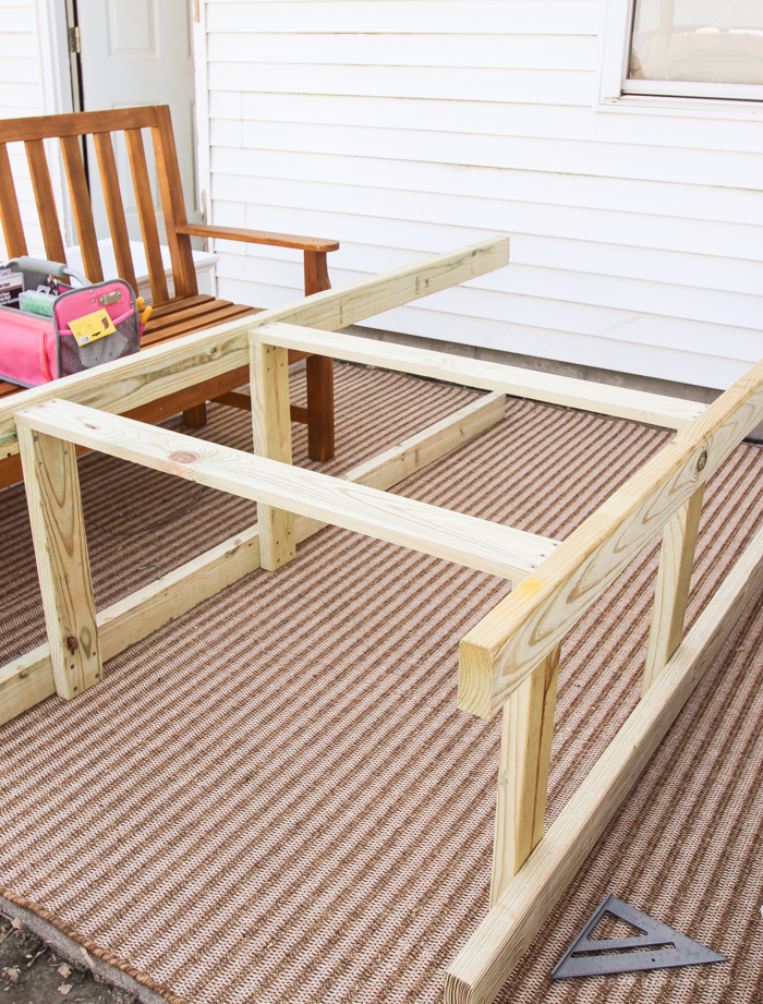 This stunning DIY potting bench is full of charm and perfect for a deck or patio! Use it to hold pots and gardening tools or as a beverage cart when entertaining guests! Full how-to at LoveGrowsWild.com