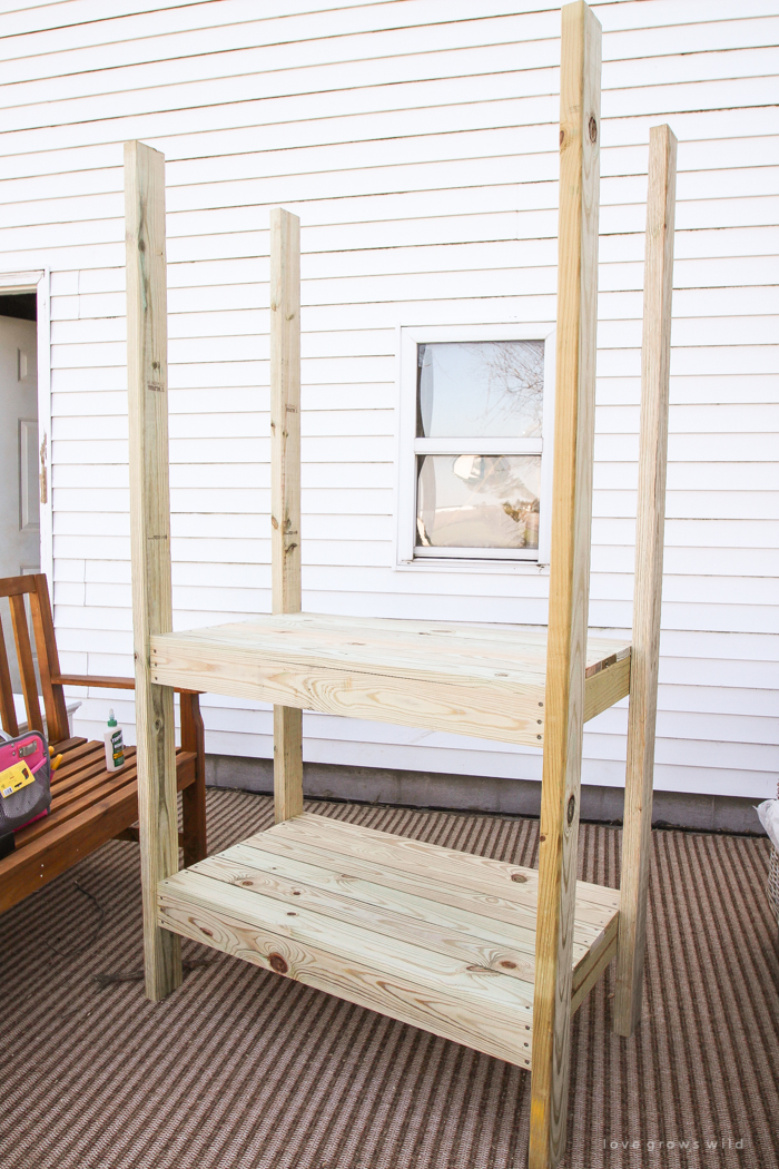 This stunning DIY potting bench is full of charm and perfect for a deck or patio! Use it to hold pots and gardening tools or as a beverage cart when entertaining guests! Full how-to at LoveGrowsWild.com