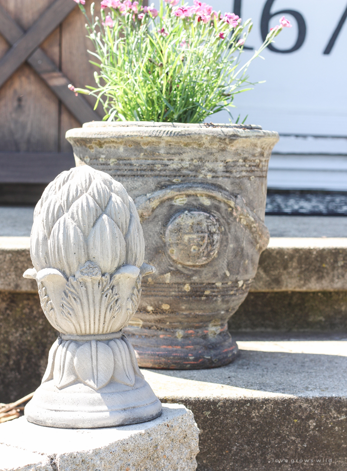 Just because you have a small front porch doesn't mean it can't be big on charm! Get ideas from this beautiful farmhouse at LoveGrowsWild.com