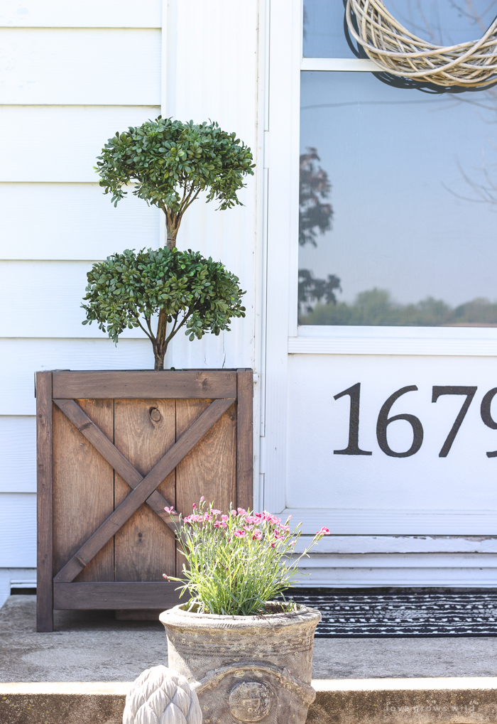 Just because you have a small front porch doesn't mean it can't be big on charm! Get ideas from this beautiful farmhouse at LoveGrowsWild.com