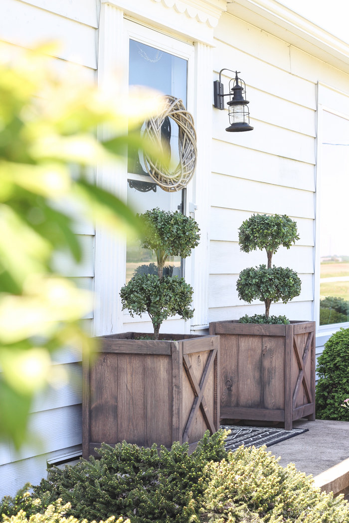 Just because you have a small front porch doesn't mean it can't be big on charm! Get ideas from this beautiful farmhouse at LoveGrowsWild.com