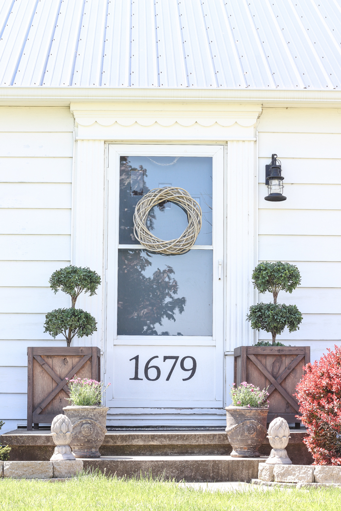 Just because you have a small front porch doesn't mean it can't be big on charm! Get ideas from this beautiful farmhouse at LoveGrowsWild.com
