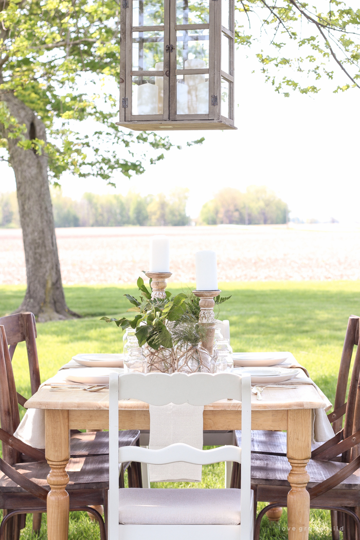 Learn how to create the perfect outdoor table setting with shopping and decorating tips from Liz Fourez. This view of her farm is stunning!