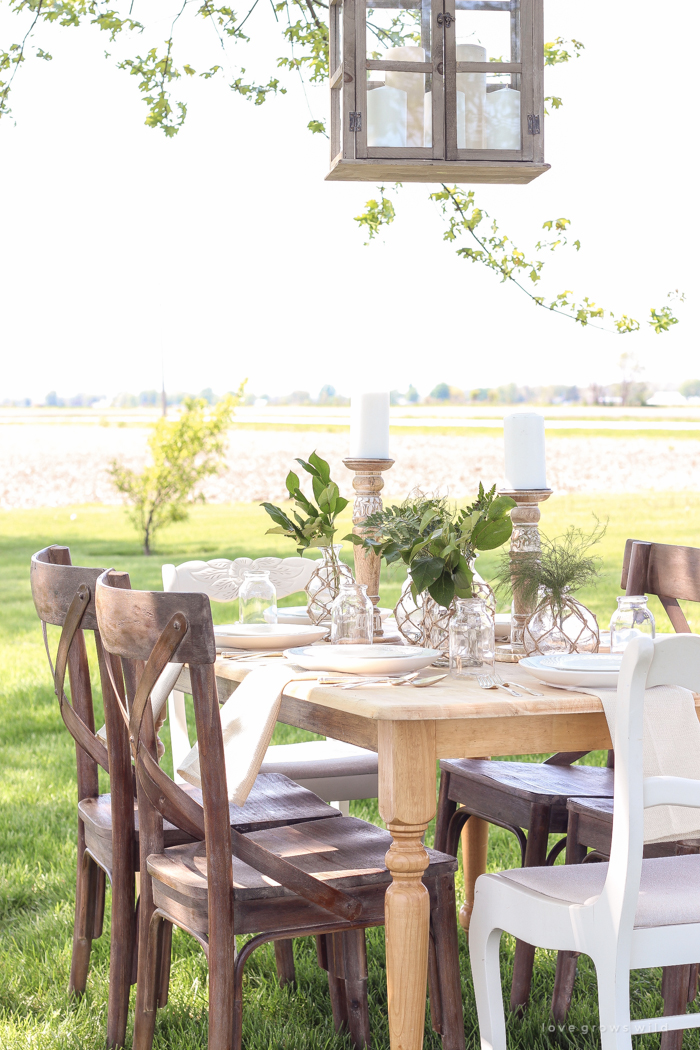 Learn how to create the perfect outdoor table setting with shopping and decorating tips from Liz Fourez. This view of her farm is stunning!